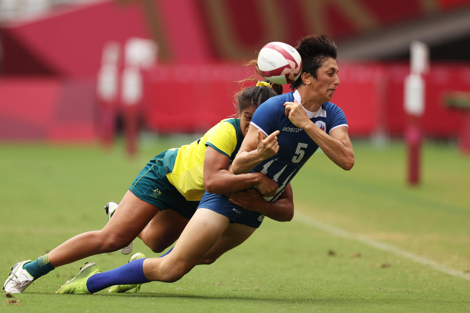 <p>Baizat Khamidova of Team ROC offloads the ball in a tackle from Sariah Paki of Team Australia in the Women’s Placing 5-8 match between Team ROC and Team Australia during the Rugby Sevens on day eight of the Tokyo 2020 Olympic Games at Tokyo Stadium on July 31, 2021 in Chofu, Tokyo, Japan. (Photo by Dan Mullan/Getty Images)</p> 