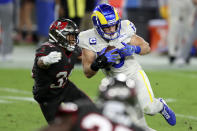 Los Angeles Rams wide receiver Cooper Kupp (10) eludes a tackle by Tampa Bay Buccaneers strong safety Antoine Winfield Jr. (31) after a catch during the first half of an NFL football game Monday, Nov. 23, 2020, in Tampa, Fla. (AP Photo/Mark LoMoglio)