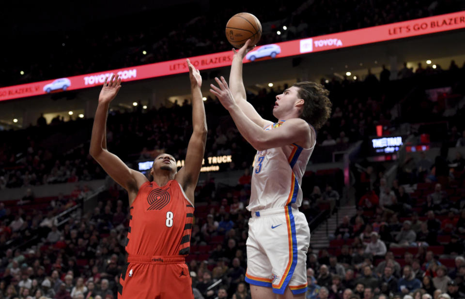 Oklahoma City Thunder guard Josh Giddey, right, shoots the ball over Portland Trail Blazers forward Kris Murray, left, during the first half of an NBA basketball game in Portland, Ore., Wednesday, March 6, 2024. (AP Photo/Steve Dykes)