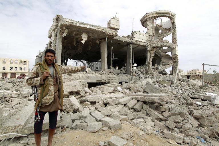 A Huthi militant points to a house in the capital Sanaa, said to belong to a Huthi leader, destroyed in an air-strike by the Saudi-led coalition on May 29, 2015