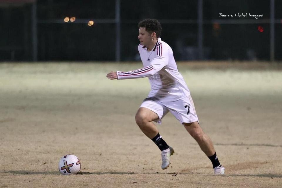 Dr. Miguel Maturana playing soccer.