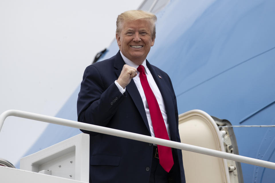 President Donald Trump pumps his fist while boarding Air Force One as he departs Thursday, May 21, 2020, at Andrews Air Force Base, Md. Trump will visit a Ypsilanti, Mich., Ford plant that has been converted to making personal protection and medical equipment. (AP Photo/Alex Brandon)