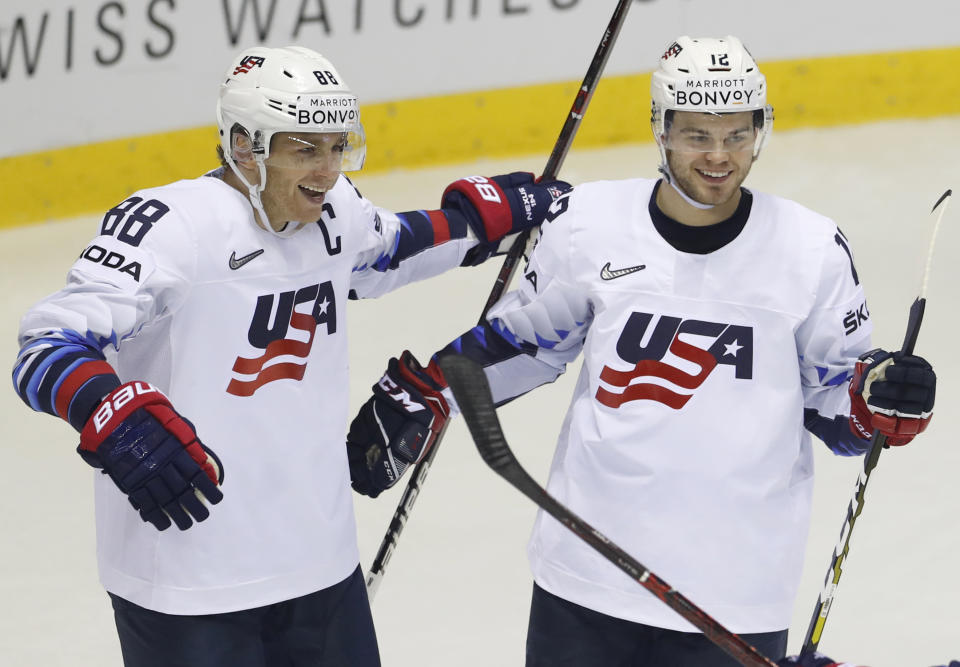 Alex Debrincat of the US, right, celebrates with teammate Patrick Kane, left, after scoring his sides fifth goal during the Ice Hockey World Championships group A match between Denmark and the United States at the Steel Arena in Kosice, Slovakia, Saturday, May 18, 2019. (AP Photo/Petr David Josek)