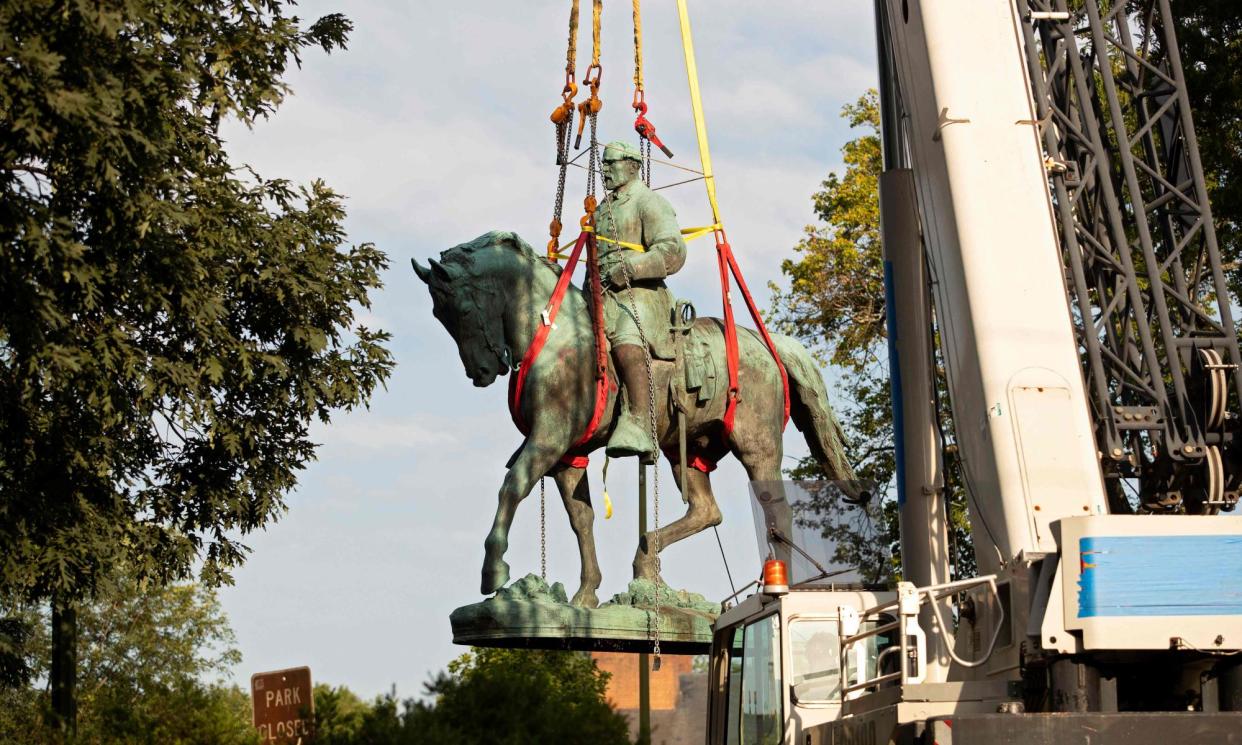 <span>A statue of Confederate general Robert E Lee being removed from a park in Charlottesville, Virginia, on 10 July 2021.</span><span>Photograph: Ryan M Kelly/AFP/Getty Images</span>