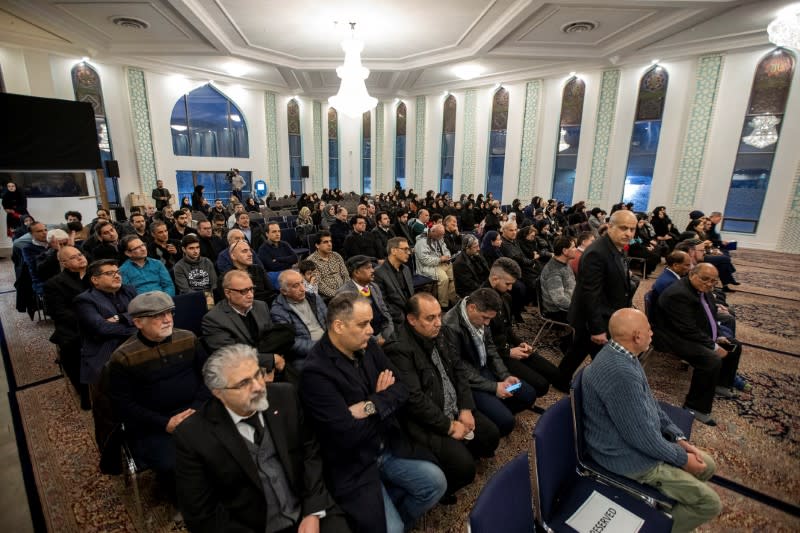 Mourners attend a memorial for the victims of a Ukrainian passenger jet which was shot down in Iran