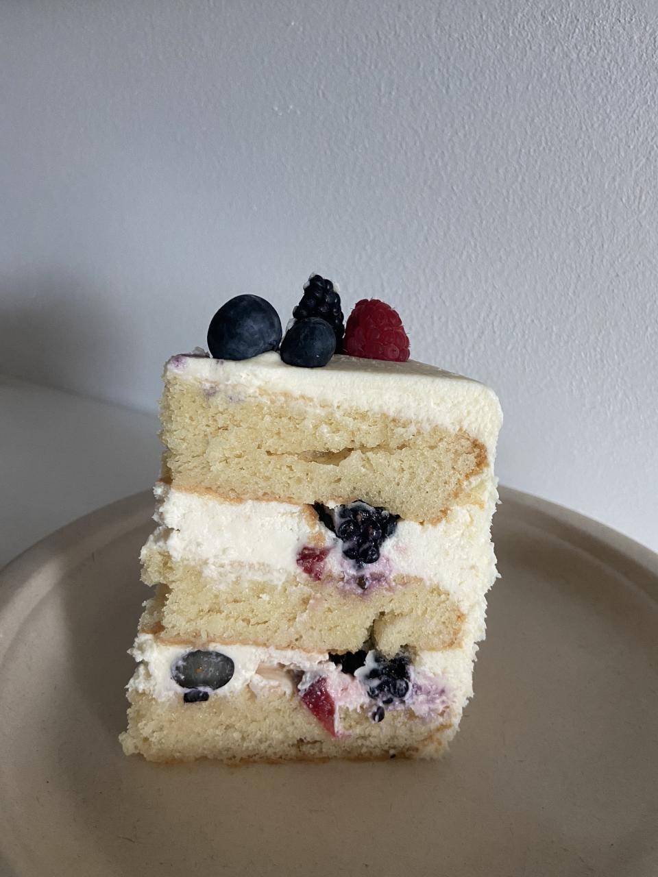 The 6-inch version has three layers of cake and frosting, with berries in the middle and on top.