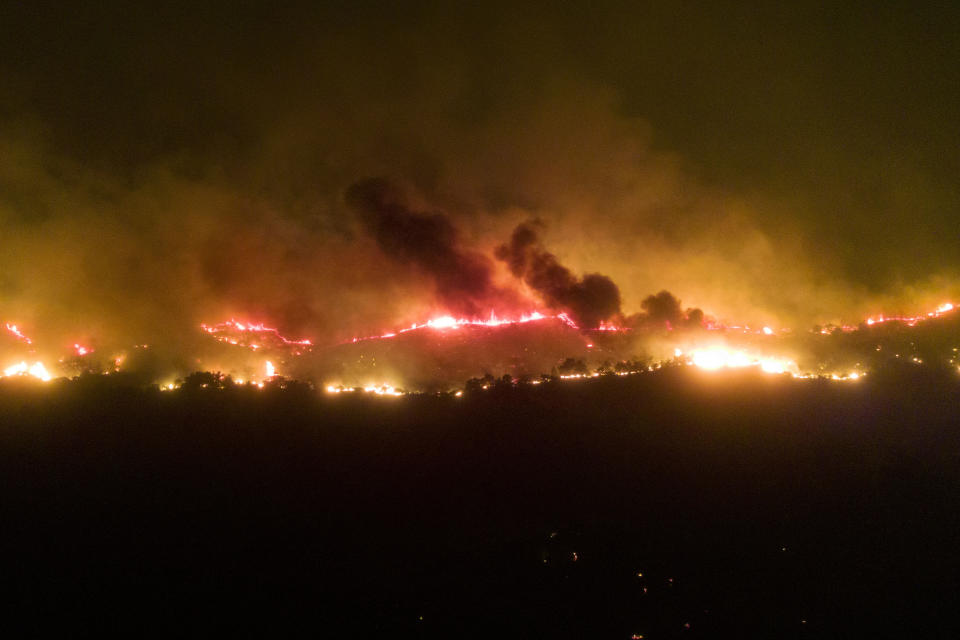 Above the village of Gennadi, huge fires continue to blaze in the evening in a patch of forest. In Greece, forest fires are raging in numerous regions. Popular vacation resorts such as the islands of Rhodes and Corfu are also affected. / Credit: Christoph Reichwein/picture alliance via Getty Images