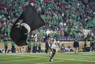 Cincinnati's Malik Vann (42) runs with the school's flag after Cincinnati defeated Notre Dame, 24-13, in an NCAA college football game, Saturday, Oct. 2, 2021, in South Bend, Ind. (AP Photo/Darron Cummings)