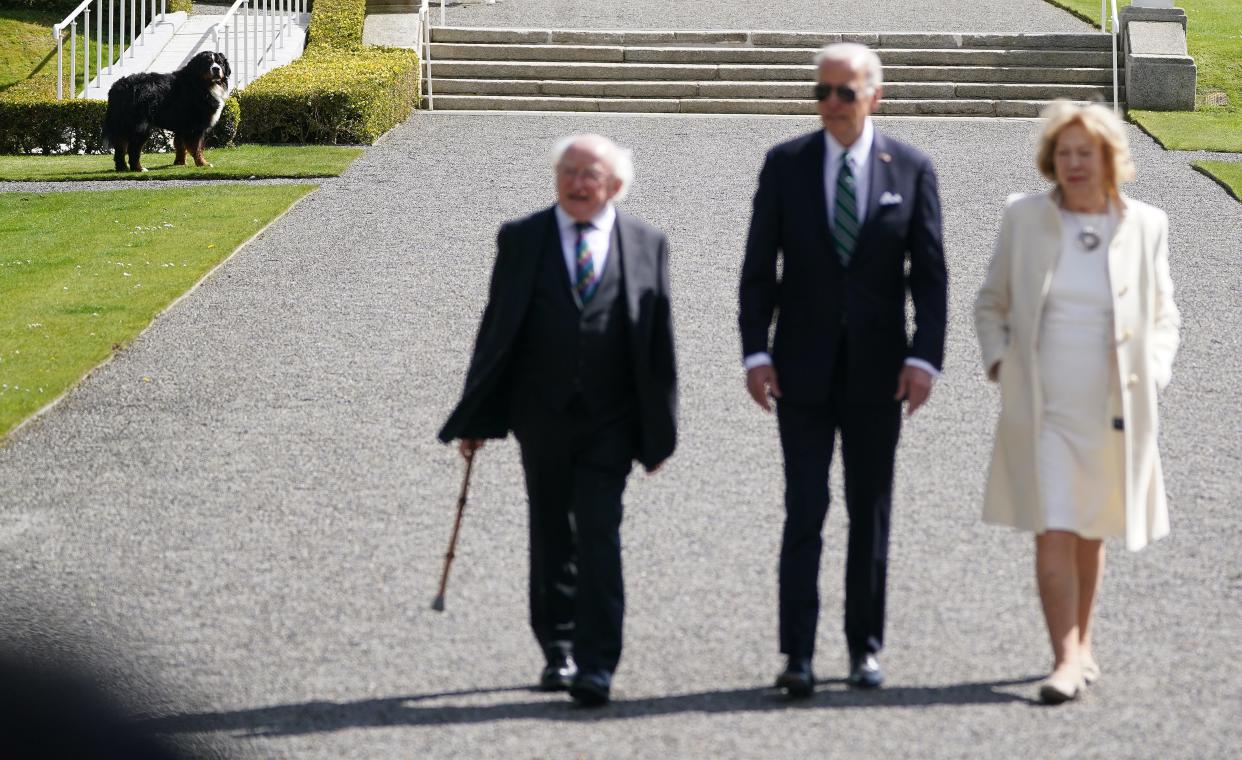 Misneach looks on as President Joe Biden walks with President Michael Higgins and his wife Sabina at Aras an Uachtarain, in Phoenix Park, Dublin, during his visit to Ireland.