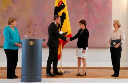 German Defence Minister Annegret Kramp-Karrenbauer receives her certificate of appointment from Berlin mayor Michael Mueller, deputising German President Frank-Walter Steinmeier, during a ceremony at Bellevue Palace