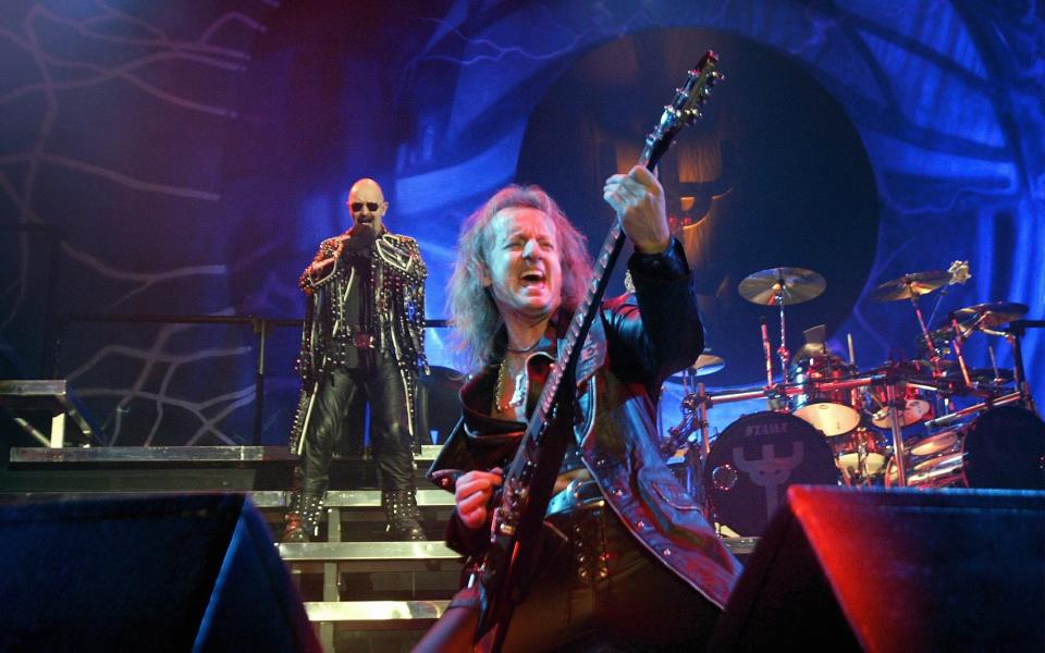 Halford with Faulkner as he performs a guitar solo - Getty