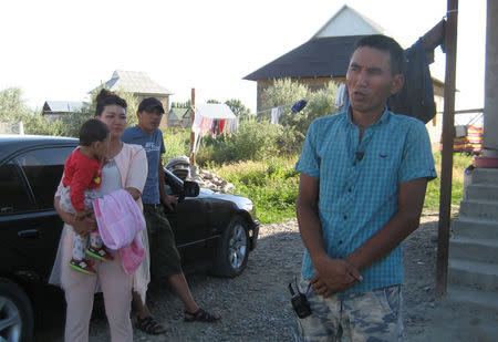 Almaz Anarbekov, brother of taxi driver Chingiz Anarbek Uulu who ploughed into crowd on June 16 in central Moscow, speaks during an interview with Reuters, as his sister Tansuluu holding Chingiz's daughter Shirin stands nearby, in the settlement of Muras-Ordo outside Bishkek, Kyrgyzstan June 17, 2018. REUTERS/Olga Dzyubenko