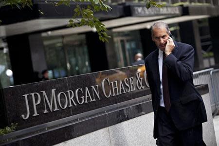 A man walks past JP Morgan Chase's international headquarters on Park Avenue in New York July 13, 2012. REUTERS/Andrew Burton