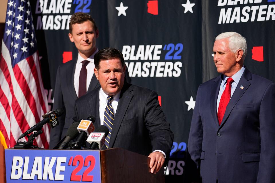 Blake Masters, the GOP U.S. Senate candidate in Arizona, holds a press conference with Arizona Gov. Doug Ducey and former Vice President Mike Pence at a school choice event on Oct. 11, 2022.