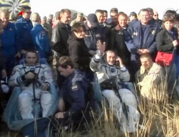 Russian cosmonaut Pavel Vinogradov (right) waves to cameras alongside NASA astronaut Chris Cassidy after a successful Soyuz landing in Kazakhstan on Sept. 10, 2013 EDT (Sept. 11 local time), ending a five-month mission to the International Spac