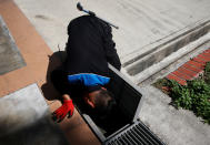 A member of a pest control team inspects drains at a Zika cluster in Singapore September 2, 2016. Picture taken September 2, 2016. REUTERS/Edgar Su