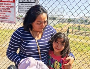 Elizabeth Barajas hugs her daughter, Marissa Perez, 9