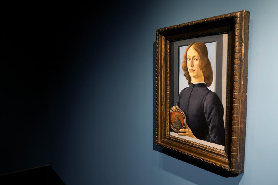 Sandro Botticelli's 15th-century painting called "Young Man Holding a Roundel" is displayed at Sotheby's on Sept. 23, 2020, in New York. The painting will go on auction next year and art watchers will be seeing if it fetches more than its eye-watering $80 million estimate, despite the pandemic. Botticelli’s 15th-century portrait of a nobleman in “Young Man Holding a Roundel” is the highlight of Sotheby’s Masters Week sale series in New York in January. (AP Photo/Seth Wenig)