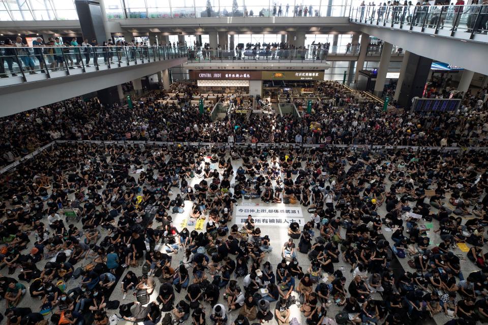 Protesters surround banners that read 