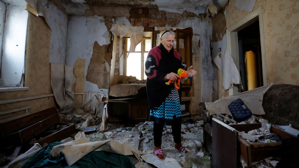 An 85-year-old resident stands inside her destroyed house in the Russian-controlled Ukrainian city of Mariupol on Tuesday. - Alexander Ermochenko/Reuters