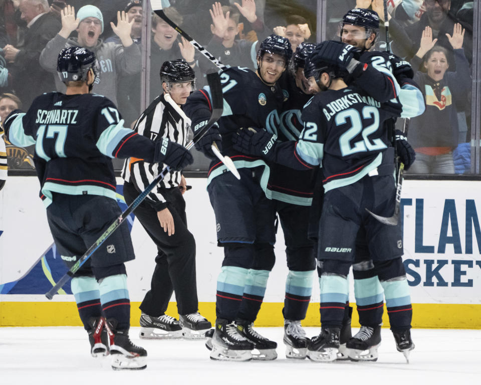 Seattle Kraken, including forward Jaden Schwartz, left, defenseman Jamie Oleksiak, far right, forward Oliver Bjorkstrand, second from right, and forward Alex Wennberg, third from left, celebrate a goal during the third period of an NHL hockey game, Monday, Feb. 26, 2024, in Seattle. The Kraken won 4-3 in a shootout. (AP Photo/Stephen Brashear)