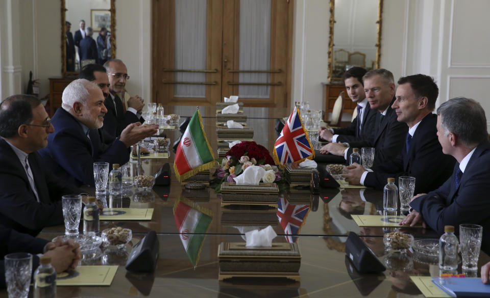 Iranian Foreign Minister Mohammad Javad Zarif, second left, speaks with Britain's Foreign Secretary Jeremy Hunt, second right, during their meeting in Tehran, Iran, Monday, Nov. 19, 2018. (AP Photo/Vahid Salemi)