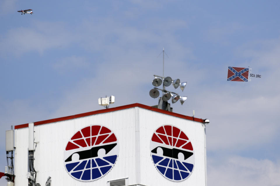 A plane pulls a Confederate battle flag over Bristol Motor Speedway before the NASCAR All-Star auto race in Bristol, Tenn, Wednesday, July 15, 2020. (AP Photo/Mark Humphrey)
