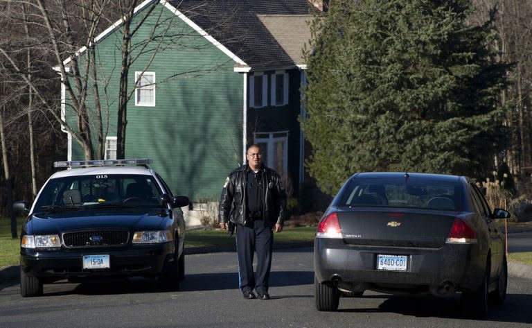 Police block a road near the house of Nancy Lanza, mother of Adam Lanza, on December 15, 2012 in Sandy Hook, Connecticut. Lanza, 20, was identified by authorities as the black-clad killer who fatally shot his mother in her home, gunned down 26 children and adults at Sandy Hook Elementary School, and then committed suicide on December 14