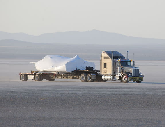 SNC's Dream Chaser test flight craft is hauled across the bed of Rogers Dry Lake at Edwards Air Force Base, Calif., to NASA's Dryden Flight Research Center on May 15, 2013.