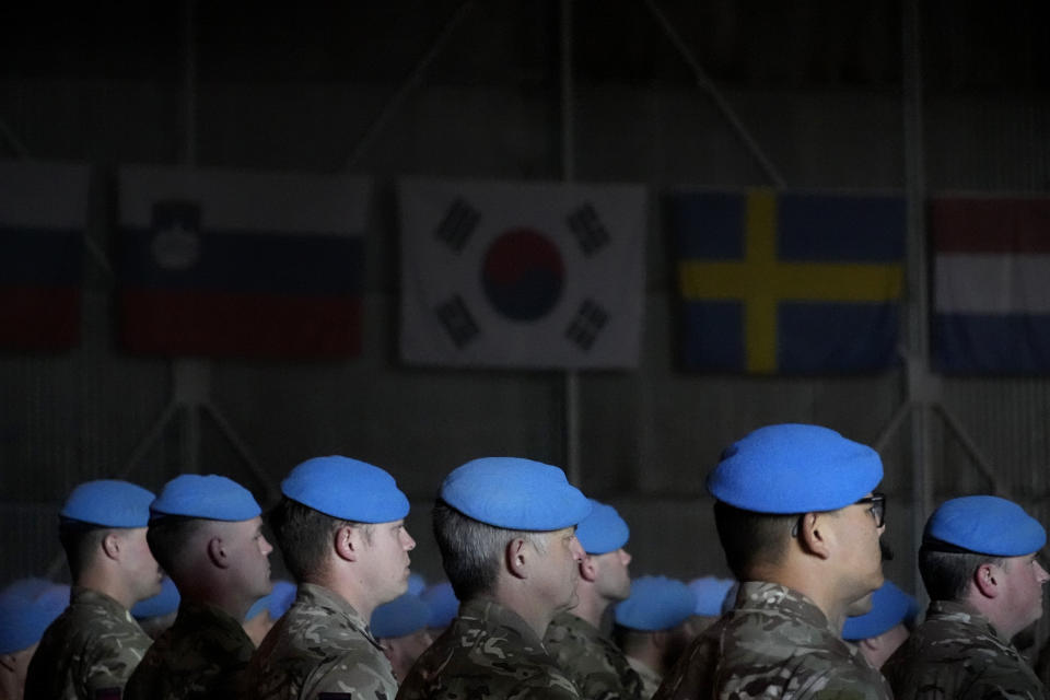 Soldiers serving with the United Nations peacekeeping force (UNFICYP) in ethnically-divided Cyprus stand during a parade marking the 60th anniversary of the force's inception, inside a U.N. controlled buffer zone that separates breakaway Turkish Cypriots in the north and Greek Cypriots in the internationally recognized south, on Monday, March 4, 2024. More than 150,000 peacekeepers from 43 countries have served with UNFICYP since 1964 with 187 soldiers and staff losing their lives while serving with the mission. (AP Photo/Petros Karadjias)