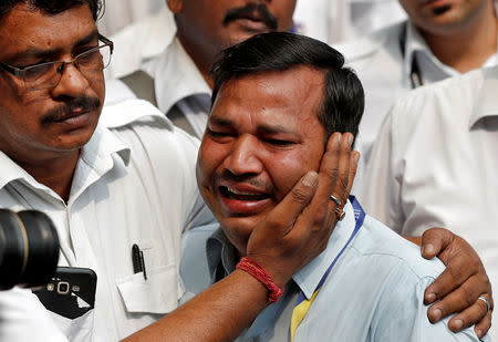 An employee of Jet Airways is consoled by his colleague during a protest demanding to "save Jet Airways" in New Delhi, India, April 18, 2019. REUTERS/Adnan Abidi