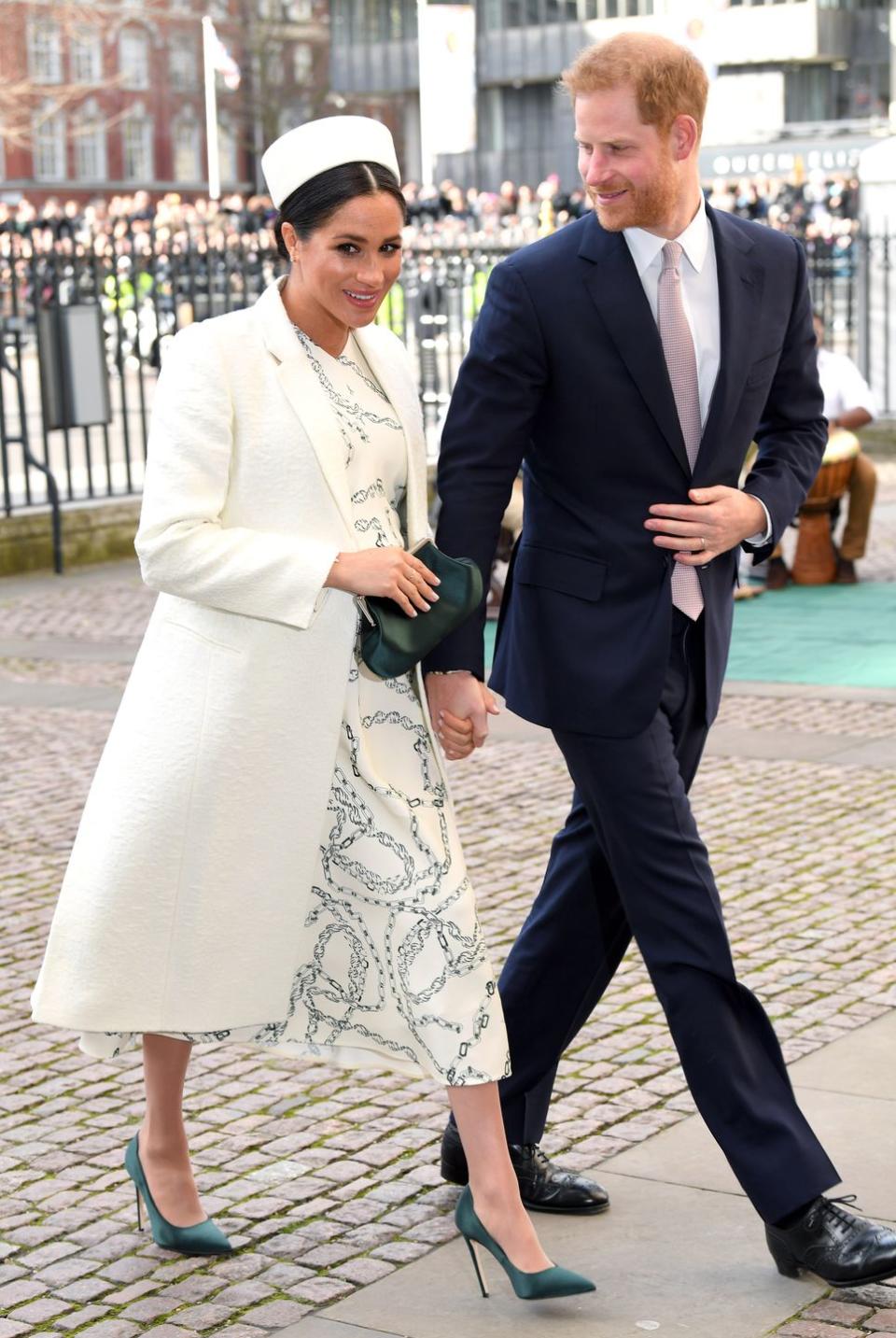 Harry and Meghan arrive at Westminster Abbey hand in hand.