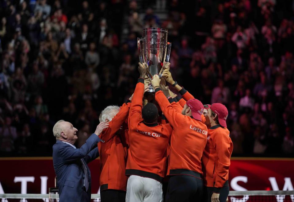 Australian tennis legend Rod Laver watches Team World celebrate with the Laver Cup trophy in London, Sunday, Sept. 25, 2022. (AP Photo/Kin Cheung)