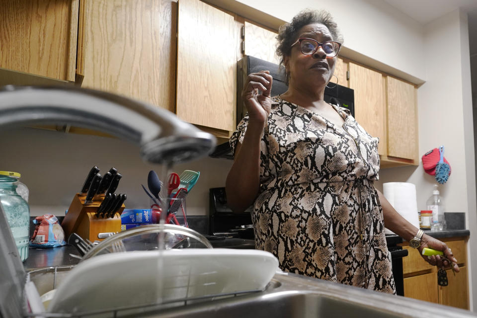 A trickle of water comes out of the faucet of Mary Gaines a resident of the Golden Keys Senior Living apartments in her kitchen in Jackson, Miss., Thursday, Sept. 1, 2022. A recent flood worsened Jackson's longstanding water system problems. (AP Photo/Steve Helber)