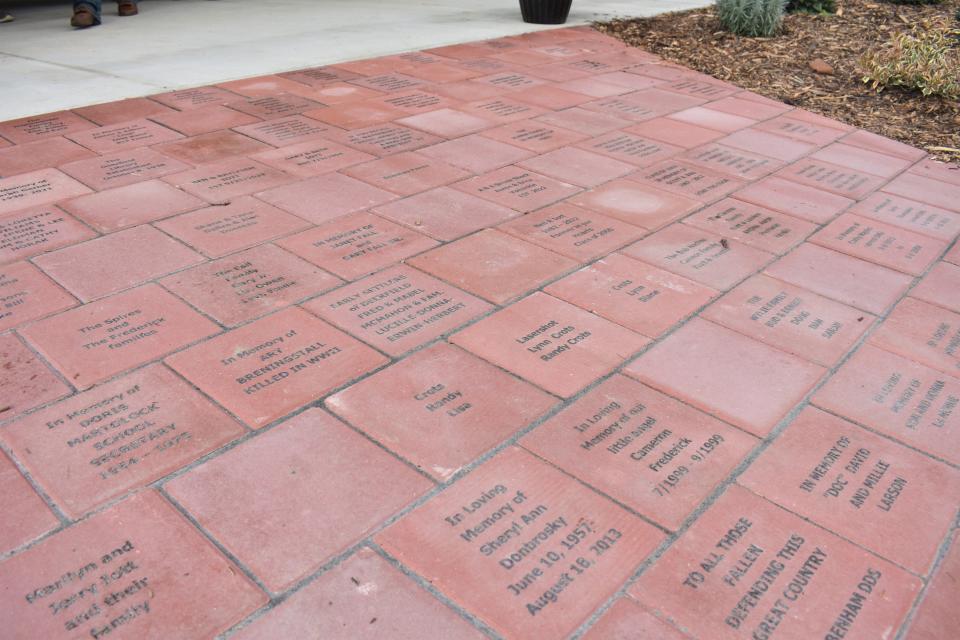 A ribbon-cutting ceremony Friday unveiled the commemorative bricks that are part of a new brick walk that commemorates a family’s history in Deerfield with engraved bricks installed at Deerfield's community park.