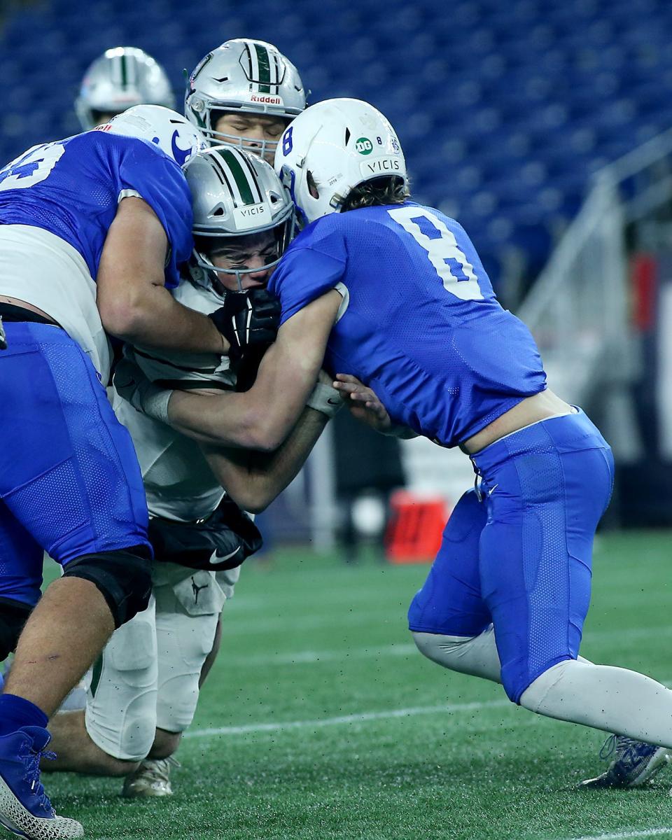 Duxbury’s Matthew Festa is tackled by Scituate’s Jamieson Holdin during third quarter action of the Division 4 state title game at Gillette Stadium on Friday, Dec. 3, 2021.