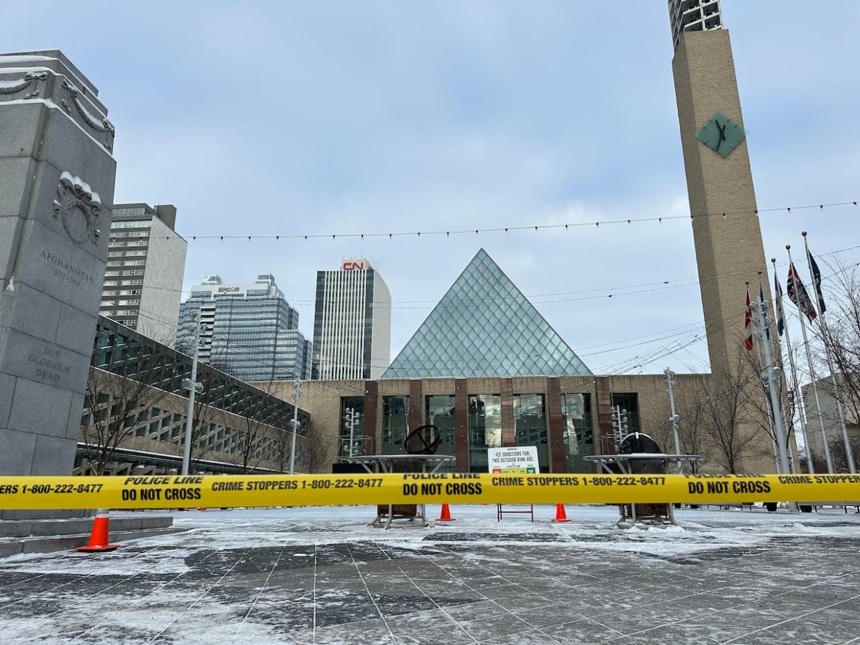 Yellow police tape is seen outside Edmonton city hall on Jan. 23 after a weapons complaint prompted an evacuation of the building. (Emily Fitzpatrick/CBC - image credit)