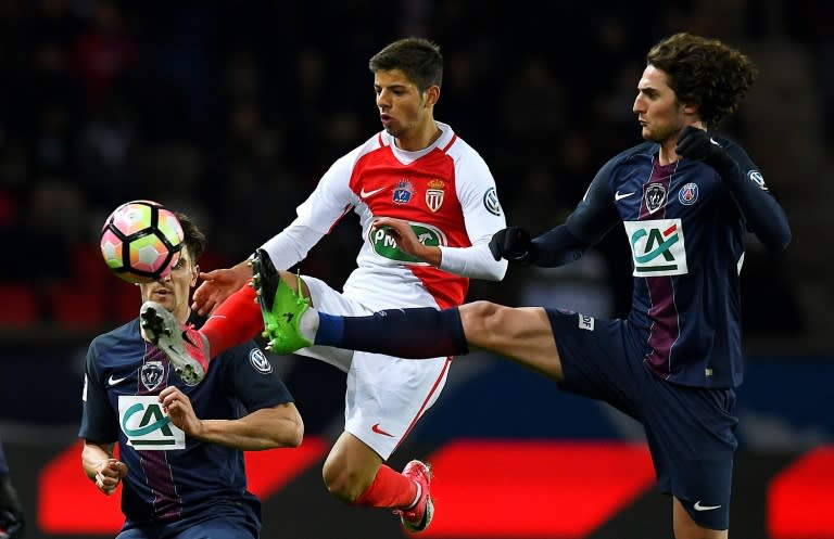 Paris Saint-Germain's midfielder Adrien Rabiot (R) vies with Monaco's forward Dylan Beaulieu(C) during the French Cup semi-final match April 26, 2017