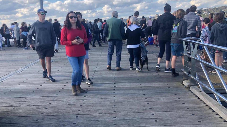 Crowds of people gather to whale watch in a Victorian suburb that is under stage three restrictions due to coronavirus. 