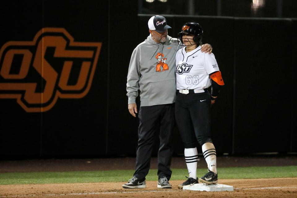 Oklahoma State coach Kenny Gajewski talks with Oklahoma State catcher Caroline Wang (66) at third base in the second softball game of a double header between the Oklahoma State University Cowgirls and the South Dakota State Jackrabbits, Tuesday, Feb. 27, 2024.