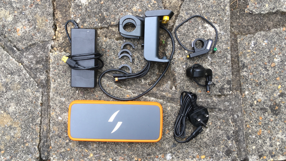 Swytch upgrade kit showing charger, bracket & spacers, display, throttle, UK plug and Max battery