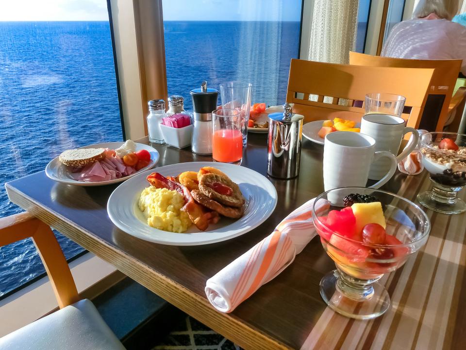 dining table on a cruise, a table filled with breakfast and cups