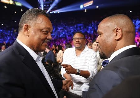 Reverend Jesse Jackson (L) arrives ringside ahead of the welterweight WBO, WBC and WBA (Super) title fight between Manny Pacquiao of the Philippines and Floyd Mayweather, Jr. of the U.S. in Las Vegas, Nevada, May 2, 2015. REUTERS/Steve Marcus