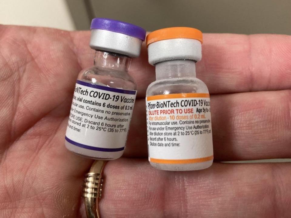 On Nov. 2, Steve Henderson, Saint Vincent Hospital's director of pharmacy, holds vials of the adult Pfizer COVID-19 vaccine, left, and the new Pfizer vaccine for children ages five to 11.