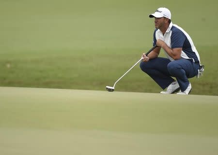 Mar 3, 2016; Miami, FL, USA; Scott Piercy lines up his putt on the 18th green during the first round of the Cadillac Championship at TPC Blue Monster at Trump National Doral. John David Mercer-USA TODAY Sports