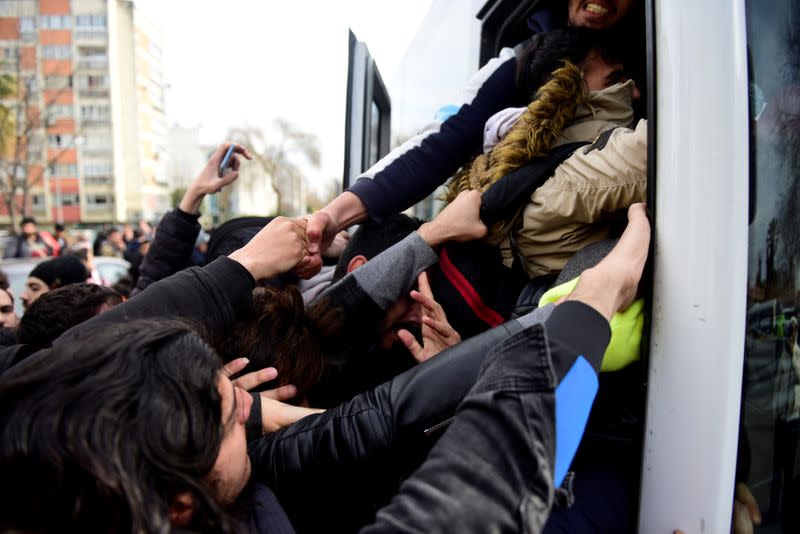 Migrants try to get on a bus which will take them to the Turkish-Greek border, in Istanbul