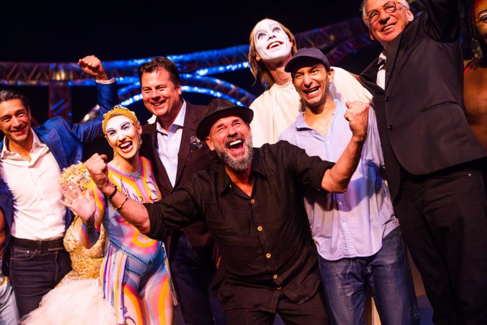 Guy Laliberté and Gilles Ste-Croix celebrate onstage during the curtain call.