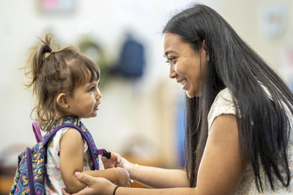 Woman dropping her daughter off at daycare