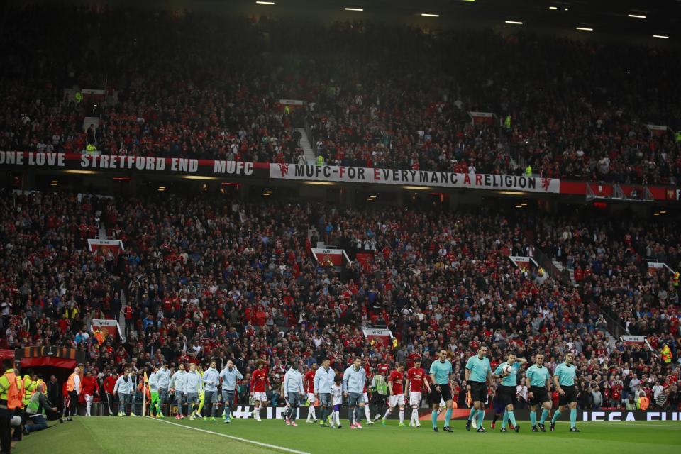 <p>The teams walk out before the match </p>