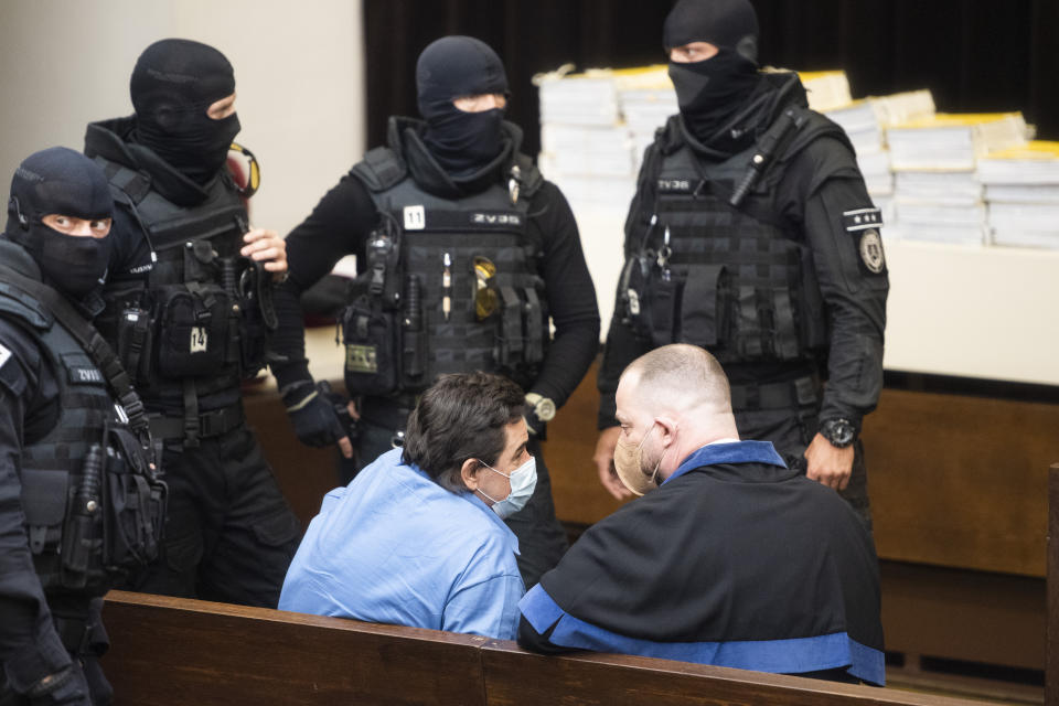 Defendant Marian Kocner, center left, and his lawyer Marek Para sit at the Supreme Court in Bratislava, Slovakia, Tuesday, June 15, 2021. Slovakia’s appeals court has dismissed a lower court verdict that acquitted a businessman accused of masterminding the 2018 slayings of an investigative journalist who had written about him and the journalist’s fiancee. The verdict by Slovakia’s Supreme Court means that the case now returns to the Specialized Criminal Court in Pezinok that ruled in September to clear the businessman, Marian Kocner, and one co-defendant of murder in the killings of journalist Jan Kuciak and his fiancee, Martina Kusnirova, both 27. (Jaroslav Novak/TASR via AP)